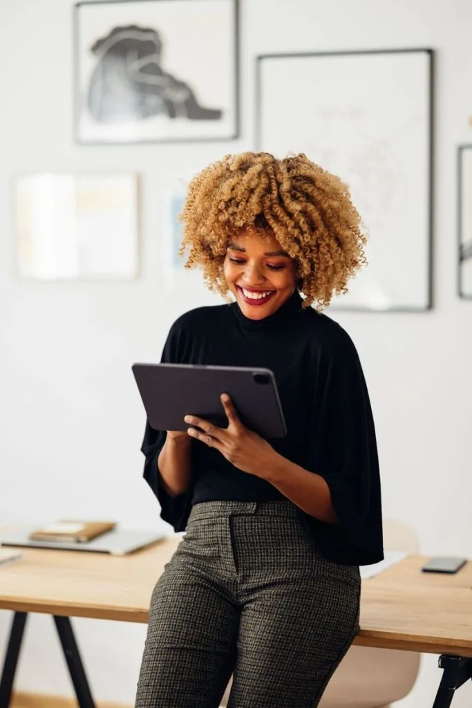 Woman working on a tablet with fiber-based connections Central New York